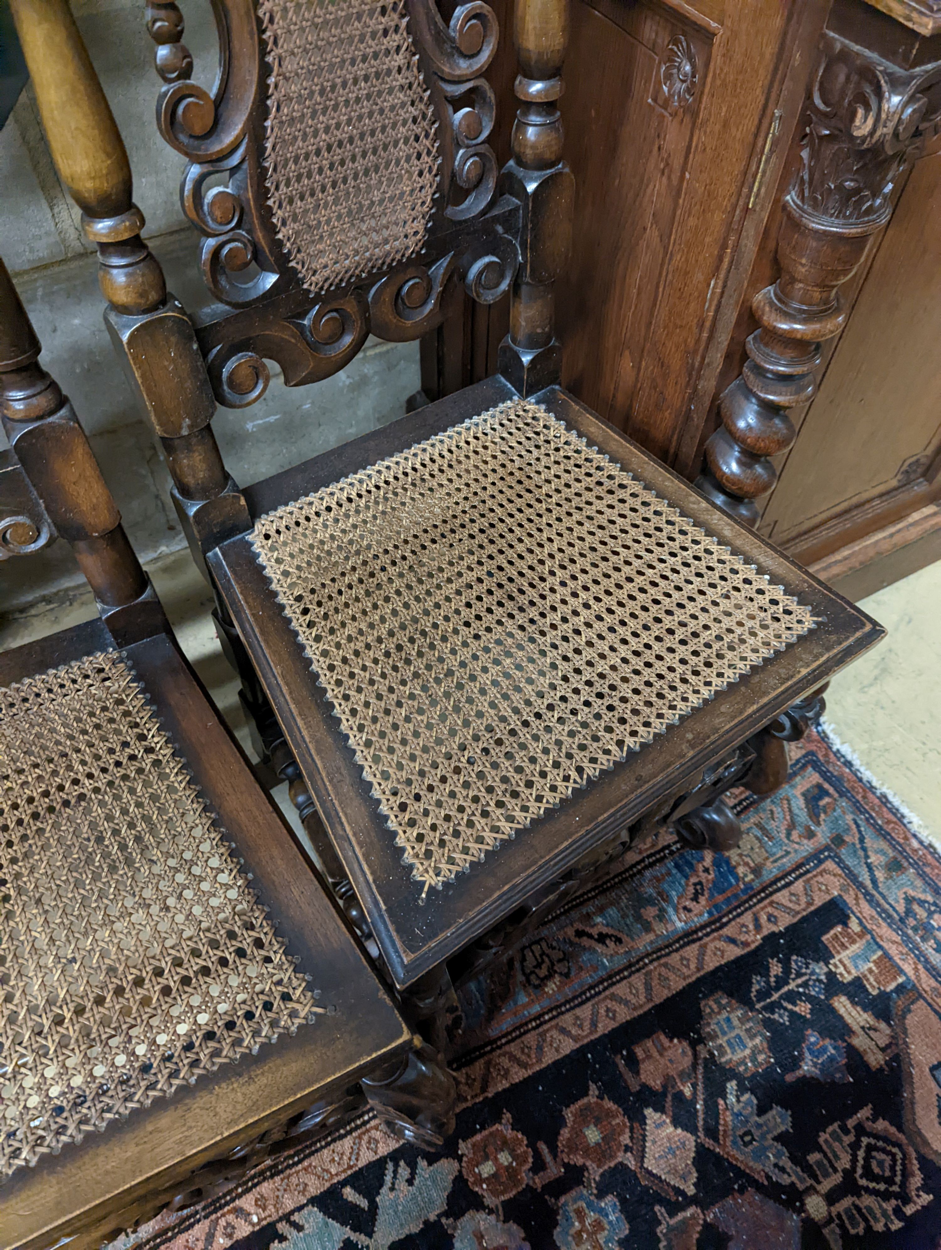 A pair of Carolean design carved beech high back chairs